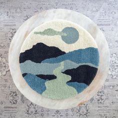 a blue and white rug on top of a wooden table