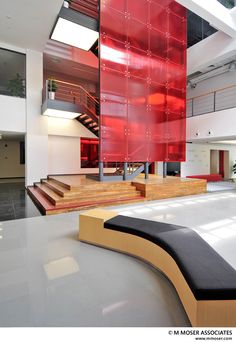 the interior of a modern building with red and white walls