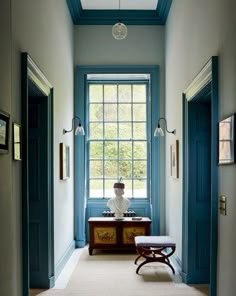 a hallway with blue trim and white walls