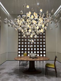 a dining room table with chairs and a chandelier hanging from the ceiling