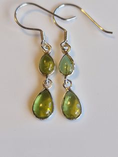 Sterling silver drop peridot  dangle  earrings with AAA green crystals handmade with care.   High quality materials, long-lasting and very sparkly.  Perfect gift for women and girls, makes an ideal stocking filler, Valentine's Day gift, Mother's Day gift, Anniversary gift and birthday gift, these earrings come gift wrapped. Some believe peridot  is derived from the Arabic faridat, meaning "gem," or from the Greek word, peridona, which means "give in abundance." Given its resemblance to the colou Long Green Earrings, Green And Silver Jewellery, Green Gemstone Drop Crystal Earrings, Green Long Drop Earrings, Nickel-free Green Drop Jewelry, Green Drop Jewelry For Jewelry Making, Green Nickel-free Drop Jewelry, Peridot Dangle Earrings With Ear Wire, Green Peridot Drop Earrings