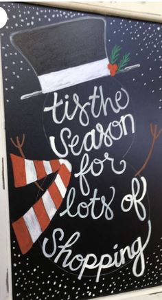 a chalkboard sign that says tis the season for lots of shopping