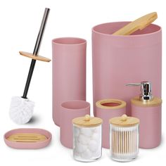 pink bathroom accessories including soap dispenser, toothbrush holder, and brush