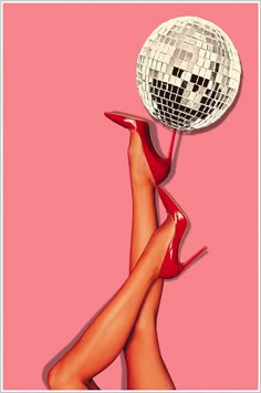 a woman's legs and heels are shown with a disco ball on her head