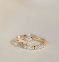 two gold wedding rings with diamonds on them