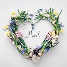 a heart shaped wreath with flowers and the word march written on it