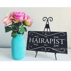 there is a blue vase with pink roses in it and a sign that says harrapist