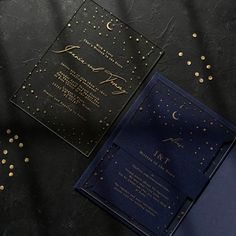 a black and blue wedding card with gold confetti on the inside is shown