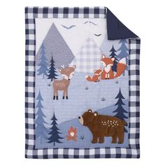 a blue and white plaid blanket with animals on the front, trees in the background