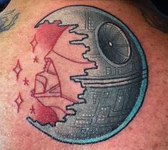 a star wars themed tattoo on the back of a man's upper arm and shoulder