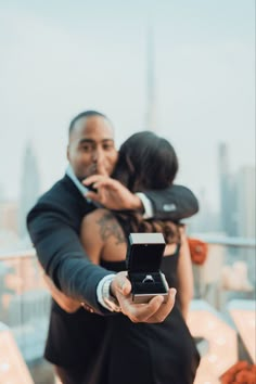 a man and woman taking a selfie with their cell phones