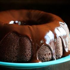 a bundt cake with chocolate icing on a blue plate