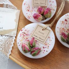 three white plates with pink flowers on them