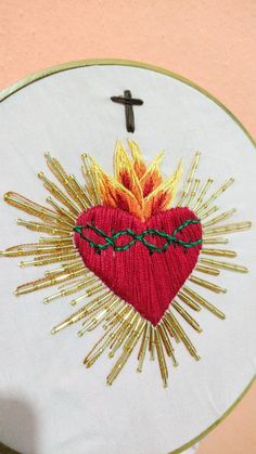 a cross and heart on a white wall hanging