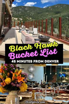 the black hawk bucket list is set up in front of an outdoor dining area with tables and chairs