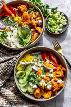 two bowls filled with different types of food on top of a table next to utensils