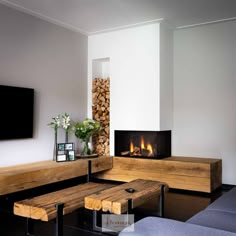 a living room filled with furniture and a fire place next to a flat screen tv