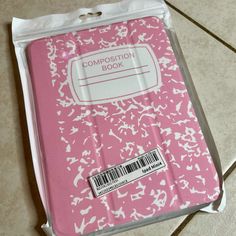 a pink composition book with white birds on it