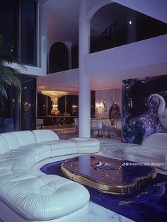 a large living room with white furniture and chandelier in the background at night