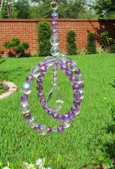 a glass sun catcher in the middle of a yard