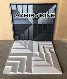 an art piece made out of white and black tiles