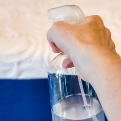 a hand holding a glass with water in it