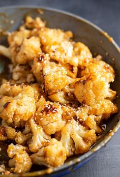 cooked cauliflower in a bowl with a spoon