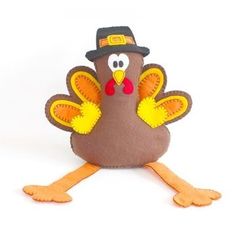 a stuffed turkey with a hat on it's head is sitting in front of a white background