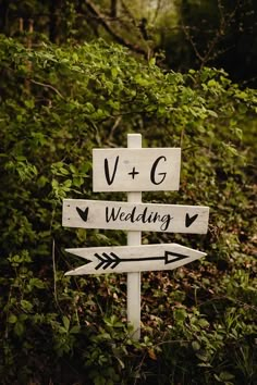 a wooden sign with arrows pointing in different directions and the words vg, wedding written on it