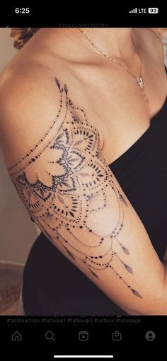 a woman's arm with an intricate tattoo design on her left arm and shoulder