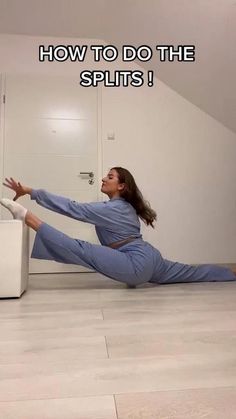 a woman in blue jumpsuits on the floor with her legs spread out and arms outstretched