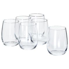 four clear wine glasses lined up next to each other