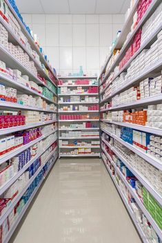 an aisle in a pharmacy store filled with lots of medicine bottles and boxes on shelves