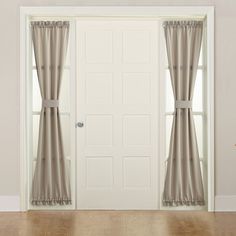 an open door with curtains hanging on the side