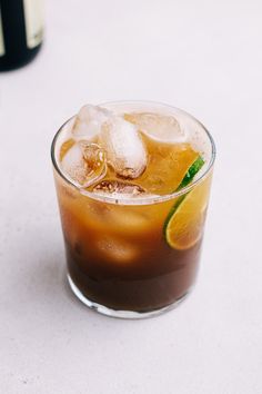 an iced drink with ice and lime garnish