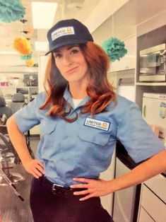 a woman in uniform is posing for a photo