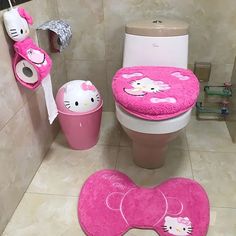 a bathroom with hello kitty rugs and toilet paper