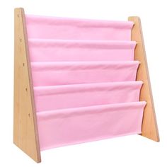 a pink book rack with six books on it's sides and two wooden legs