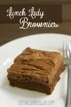 a close up of a piece of cake on a plate with the words lunch lady brownies