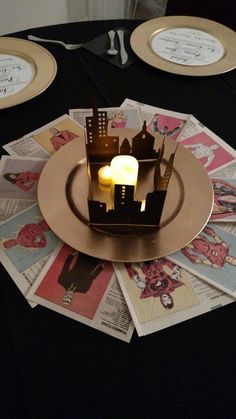 a plate with a lit candle on top of it next to some plates and napkins