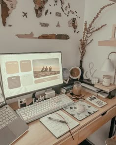 a desk with a computer, keyboard and mouse on it in front of a world map