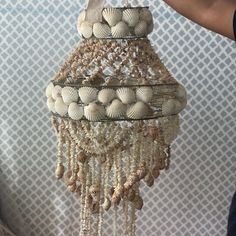 a chandelier with shells hanging from it's sides