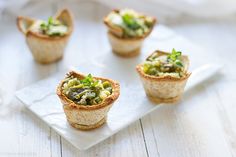 small cups filled with food sitting on top of a white plate