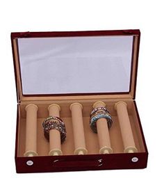 four rings are in a wooden box with glass inserts on the top and bottom