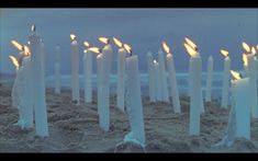 there are many candles that are in the sand