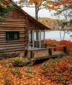 a log cabin sitting next to a body of water