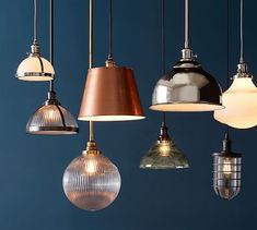 an assortment of pendant lights hanging from the ceiling