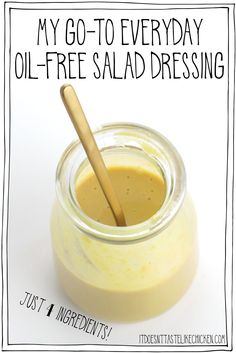 a jar filled with liquid and a wooden spoon in it that says, my go - to everyday oil - free salad dressing