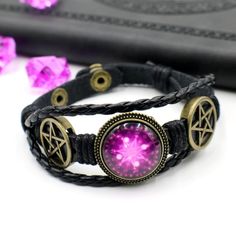 This black faux leather bracelet features a purple wiccan magic circle. The metal parts are made from electroplated zinc alloy while the featured magic circle is made from curved glass. The total length of the bracelet is 215mm and it is adjustable between two sizes (175mm and 195mm). International Shipping - Registered Airmail Once you have made your purchase please allow for 3-4 business days for us to package and ship your item. Once it is shipped you will receive a tracking number with China Magic Bracelet, Wiccan Magic, Faux Leather Bracelets, Dark Magic, Circle Bracelet, Magic Circle, Wedding Jewelry Bracelets, Curved Glass, Wax Stamp