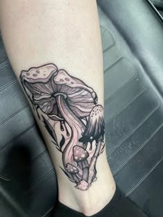 a tattoo on the leg of a woman with an octopus and jellyfish in it